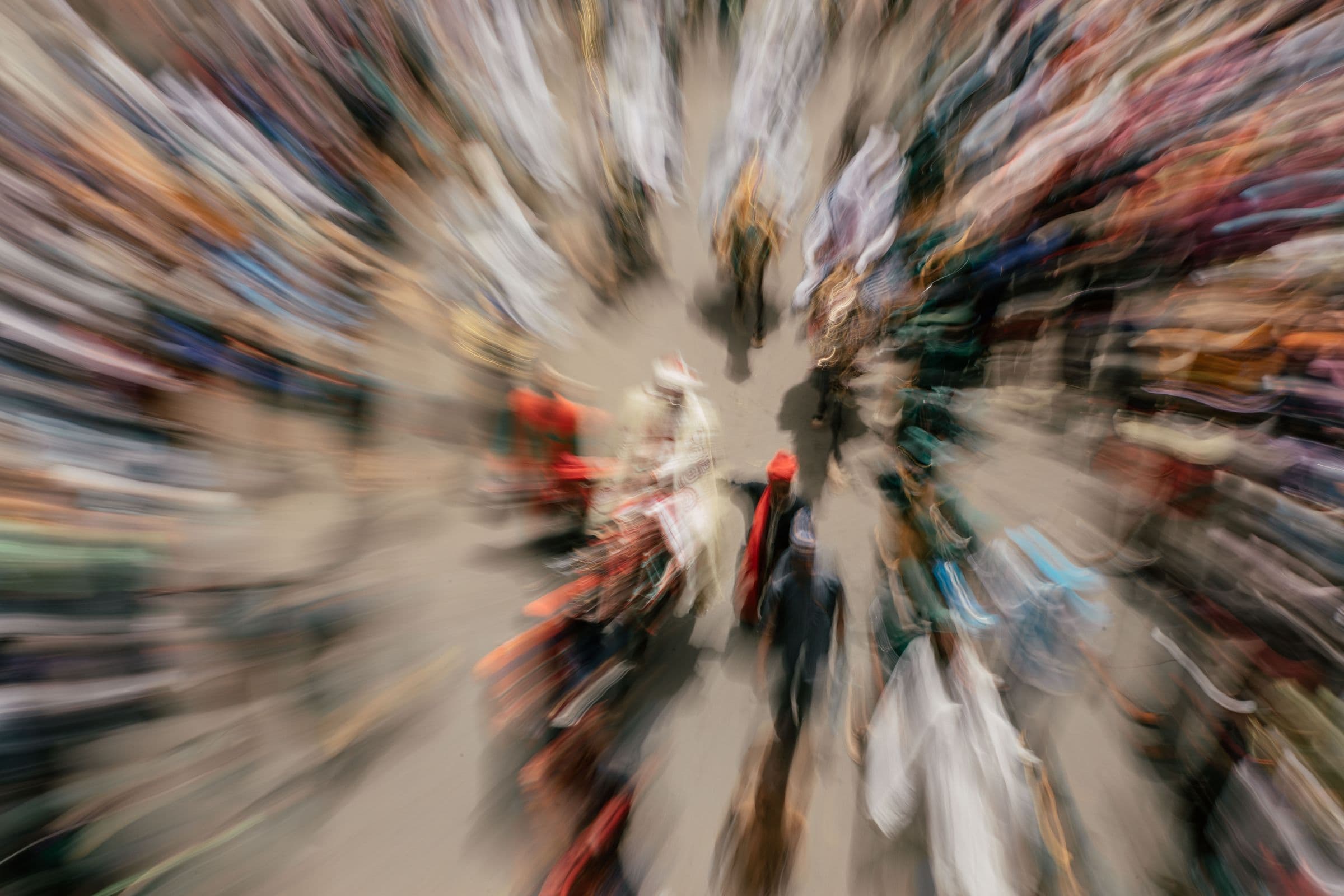Zoom blur effect capturing a diverse crowd at an outdoor event, creating a sense of motion and energy.